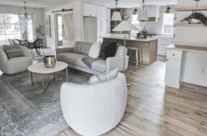 Living room + open kitchen - gray scales, gold and wooden ornaments.